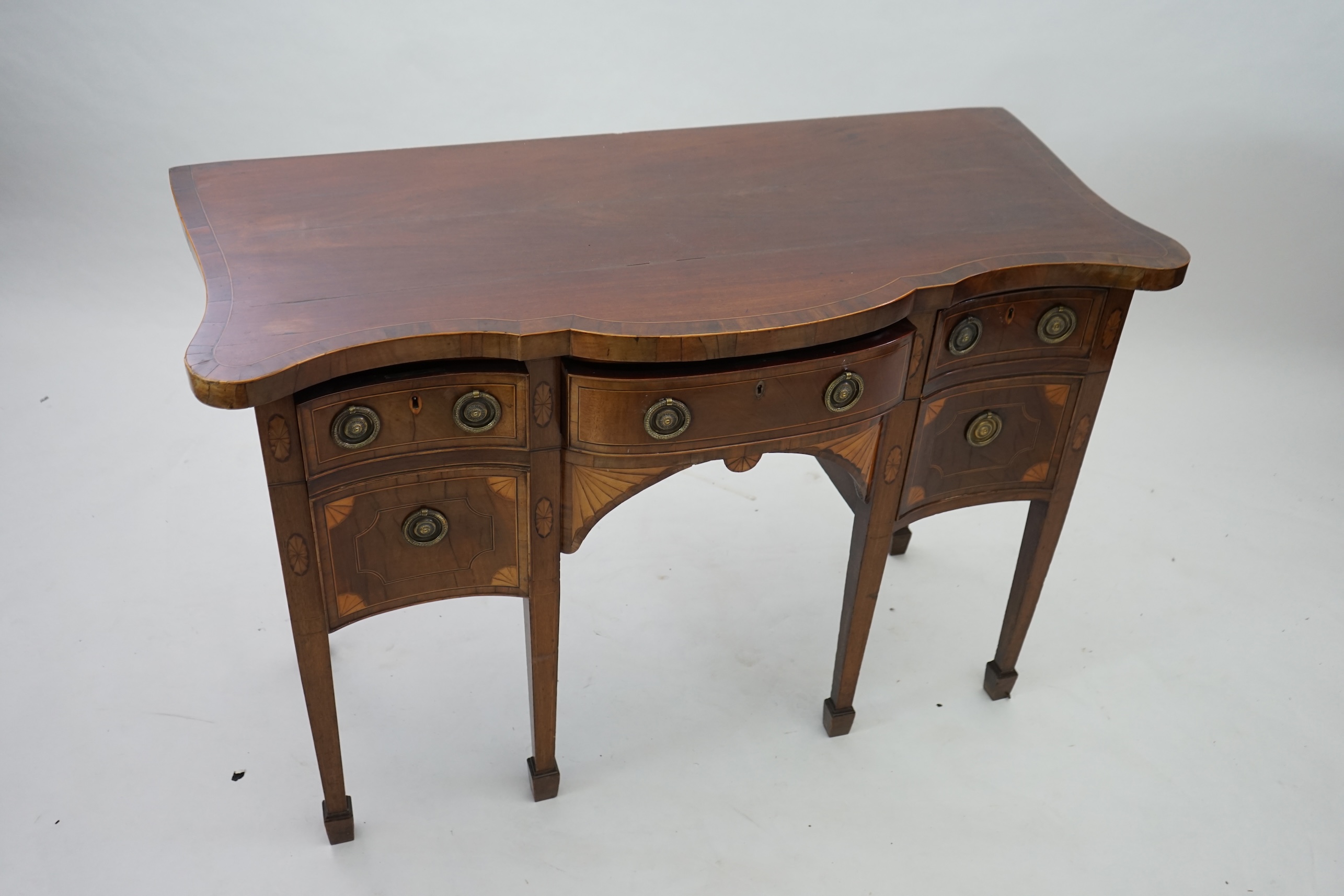 A George III inlaid mahogany serpentine sideboard